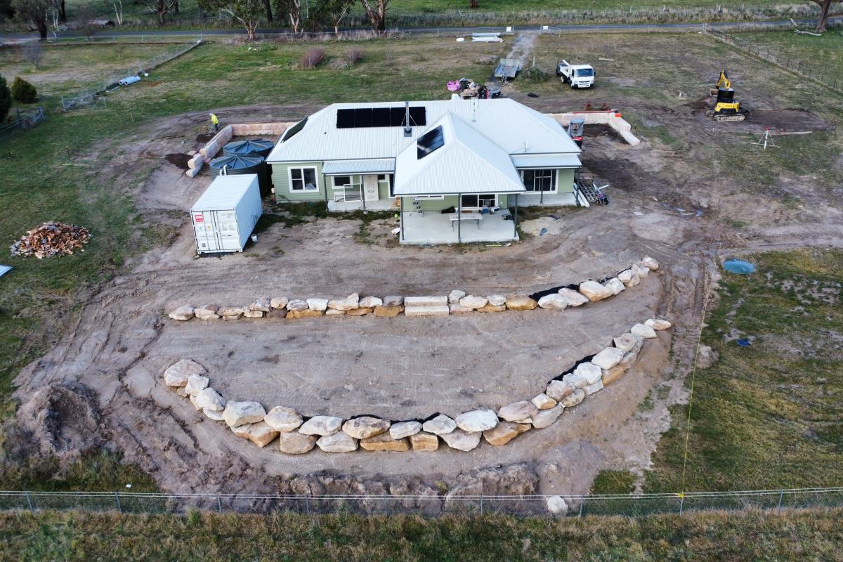 Aerial view of sandstone log retaining walls on an excavated block