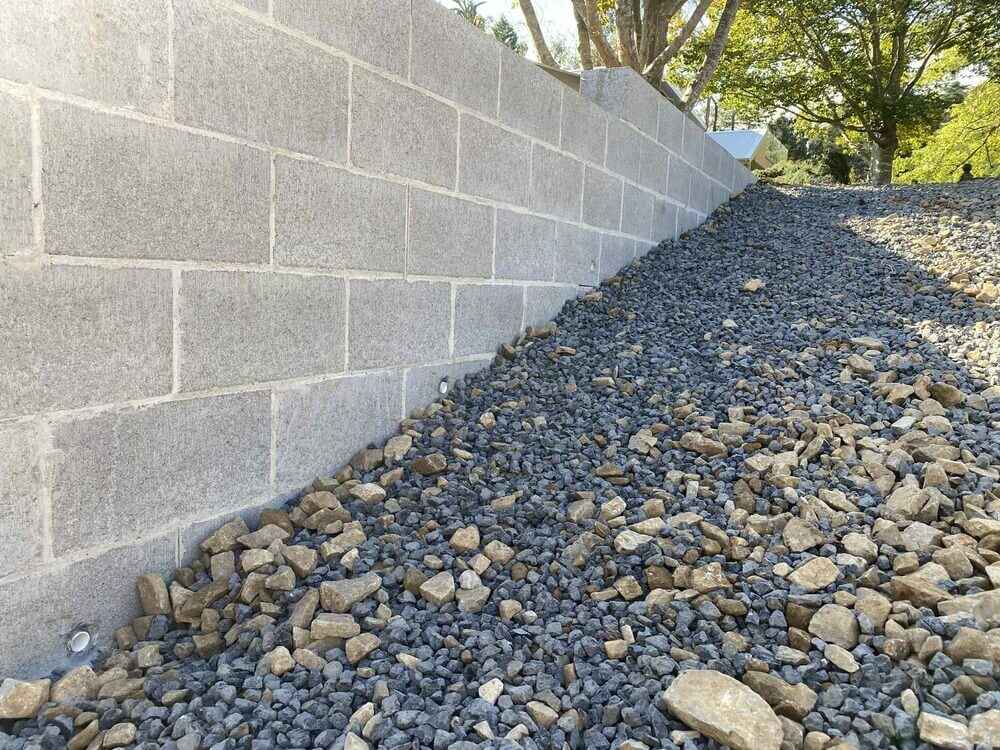 Concrete block retaining wall with gravel drainage backfill in Wentworth Falls