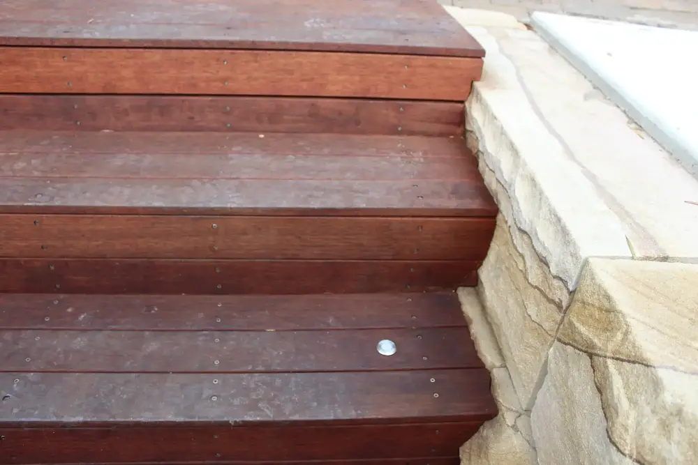 Close-up of squared sandstone blocks beside timber steps in Blaxland